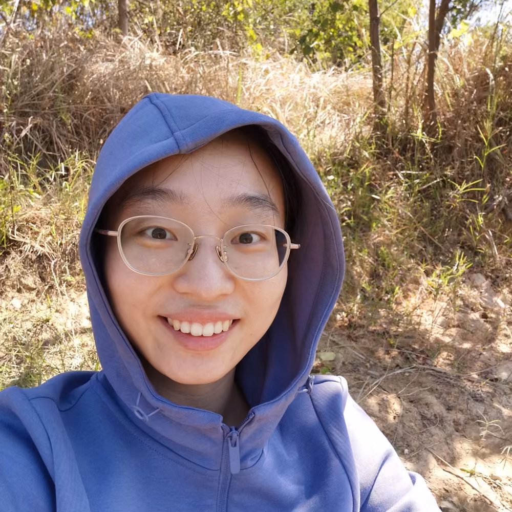 I am Li. I am wearing a blue hoodie.